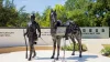 A brown/bronze colored statue of William H. Thompkins and his horse during the Spanish-American War