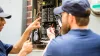 Two guys looking at an electrical panel