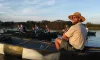 The park ranger and several people on a lake in canoes