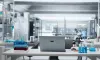 A laboratory with a computer, blood vials, test tubes, and other scientific equipment