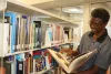 Taking a look at a book at the local library.