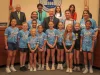 Members of the softball team in front of the Board dais along with some of the commissioners