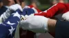 The American flag being folded during a memorial tribute to veterans