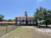 Facing North, showing Old Lutz Schoolhouse's cupola and chimney.