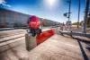 A closeup of a railroad crossing bar