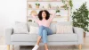 Woman relaxing on couch in clean home.