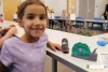 Young girl with Play-Doh projects of a snail and tree. Tampa-Hillsborough County Public Library offers fun programming for kids and teens to keep them engaged during summer break.