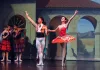 A male and female ballerina in Spanish style costumes prepare to bow to the audience