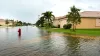 a flooded street in residential neighborhood