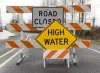 Road closed and high water street signs on road