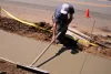 A worker installs a new sidewalk