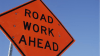 Orange road work ahead sign