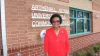 Arthenia Joyner stands outside the library named in her honor