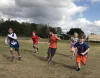 Kids running around on a outdoor field