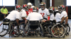 Players huddle up in a circle in their wheelchairs