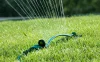 Image of sprinkler watering a lawn