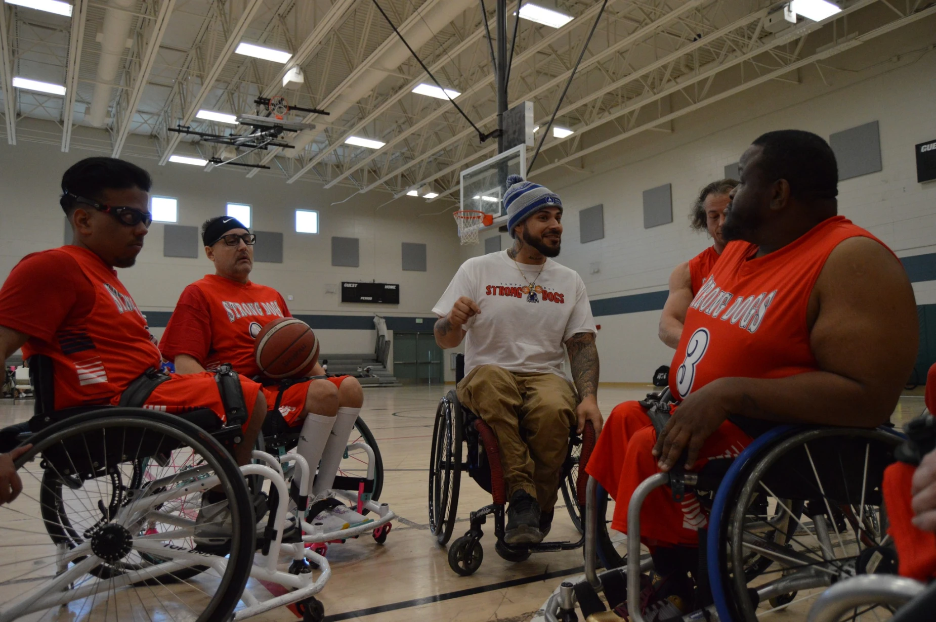 The Strong Dogs talking with their coach on the court