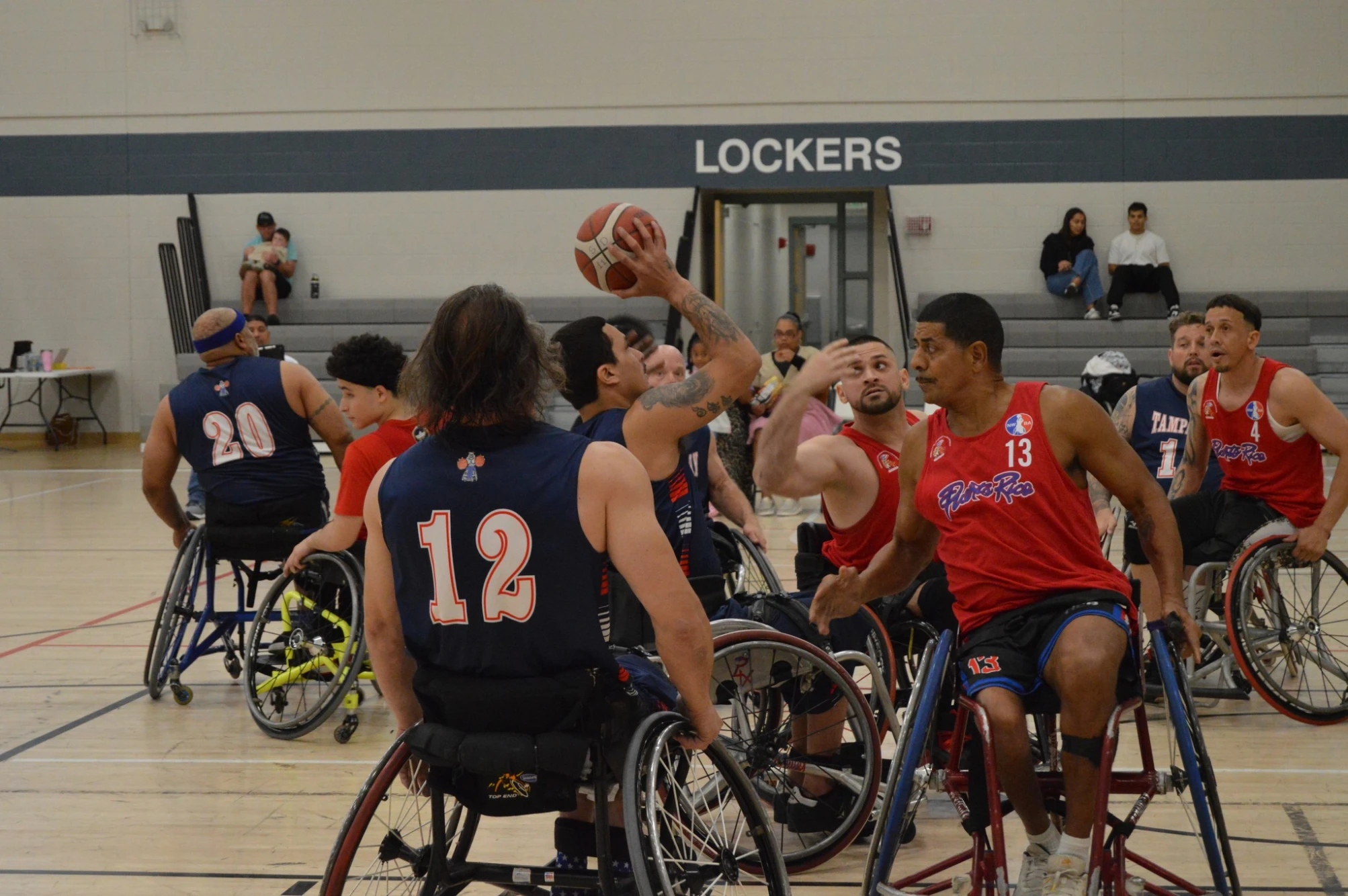 The Strong Dogs competing against Puerto Rico with a Strong Dogs team member getting ready to shoot a basket while the other team tries to stop him