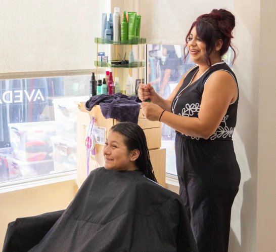 Cecilia, age 14, has her hair done by stylist Karla Palacios at Foil and Hue Salon.