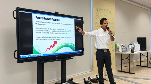 Tony Selvaggio stands in front of a TV monitor with a slide for Future Growth Potential on it