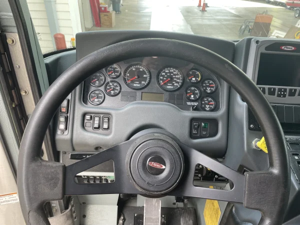 A fire engine's dashboard includes numerous gauges, including those for miles per hour (MPH), revolutions per minute (RPM), fuel, volts, oil, water temperature (of the cooling system fluid), and transmission temperature.