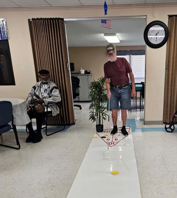 Two people playing shuffle board