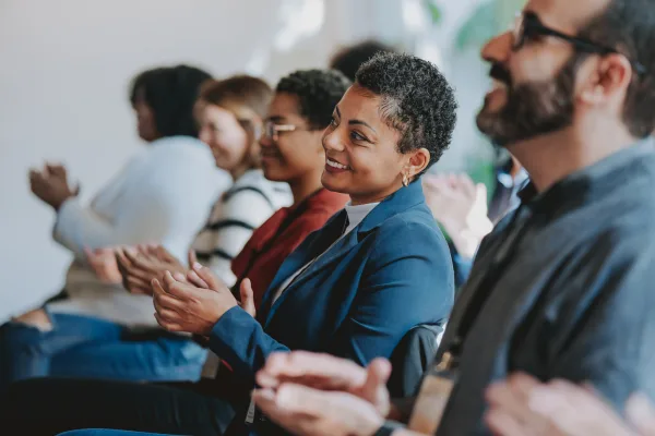 Woman watching panel of speakers