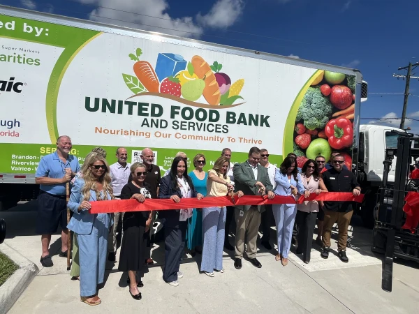 Representatives from Hillsborough County, United Food Bank and Services, Publix Super Markets Charities, The Mosaic Company, and community partners celebrate the addition of a new refrigerated box truck and forklift during a ribbon-cutting ceremony on June 23, 2026 in Tampa, Fla.