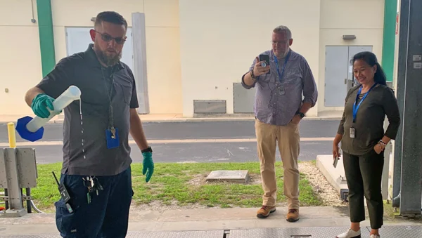 Dean Lampman, shift leader for the Falkenburg Wastewater Treatment Plant, demonstrates to Hillsborough County science teachers the clarity of reclaimed water that has been treated.