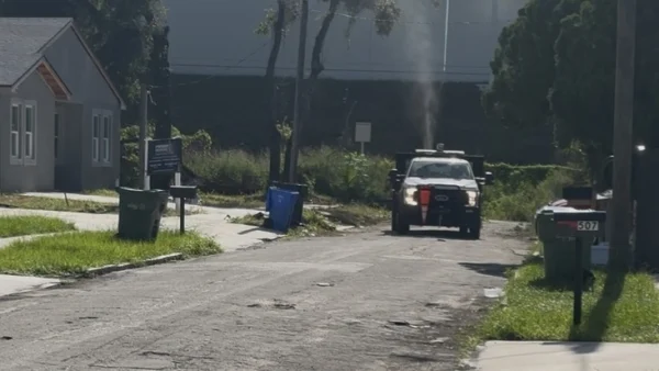 A mosquito truck spraying in neighborhood