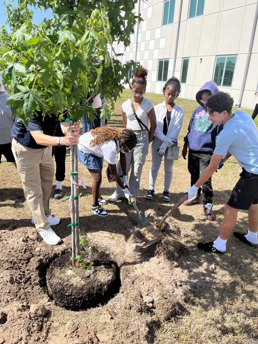 Students at Giunta Middle School participate in the County's Classroom to Canopy Program by helping to plant a tree.