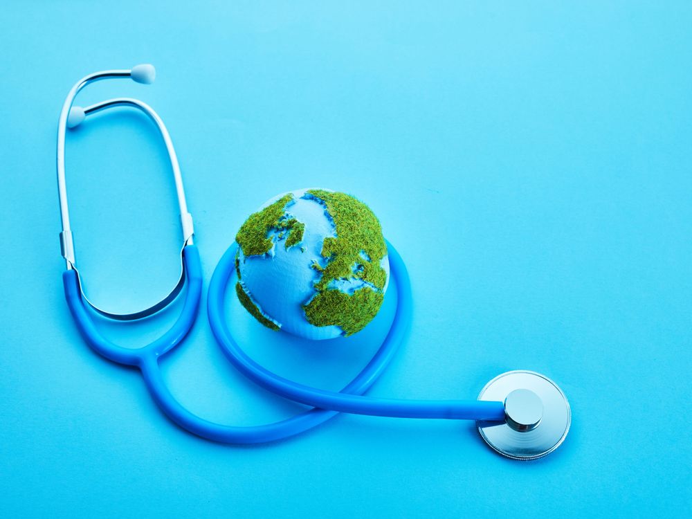 Stethoscope surrounding the globe on a blue background