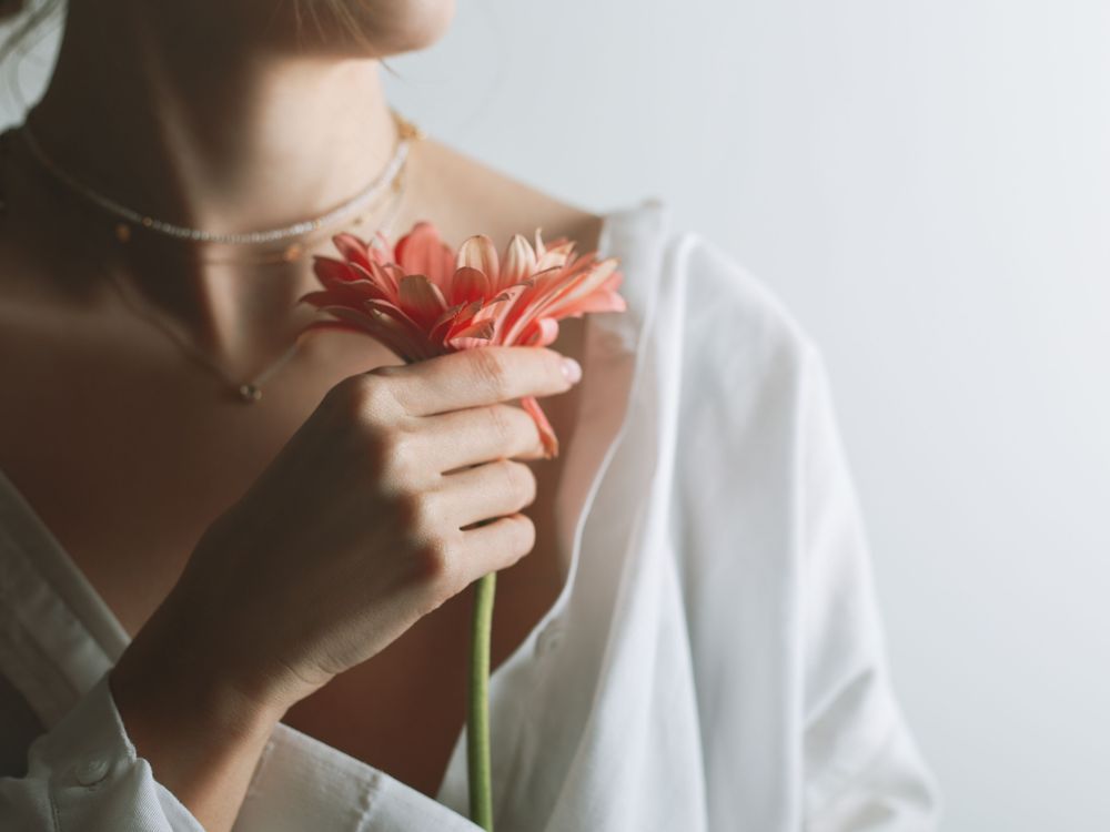 woman with a flower in her hand