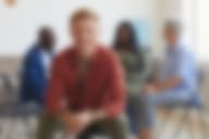 Smiling man at group therapy session