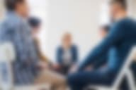 A person receives support from a group therapy session