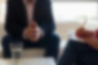 A professional takes notes during a ptsd treatment talk therapy