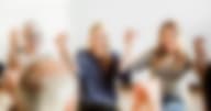 Group of diverse people holding hands up in the air