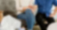 Couple holding hands sitting on a sofa