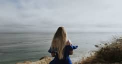 A woman sitting alone at a beach