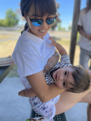 Person smiling with their recently born baby