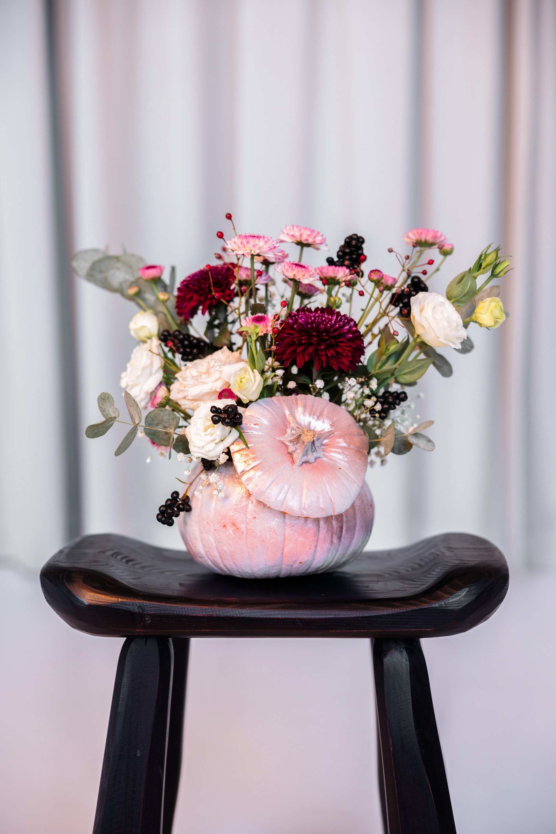 Wedding bouquet in shades of white, blush and burgundy, tied with ribbon