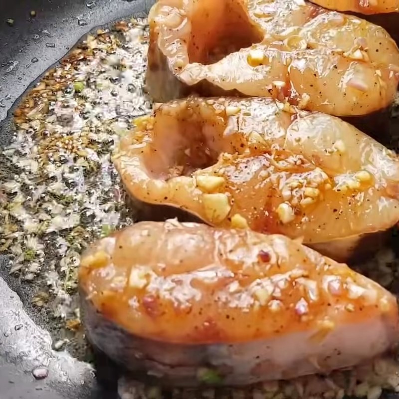 Chiên sơ khoanh cá cho săn mặt trong chảo hành tỏi phi thơm