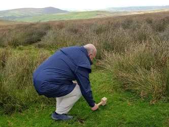 Driving a stake in a Welsh hilltop