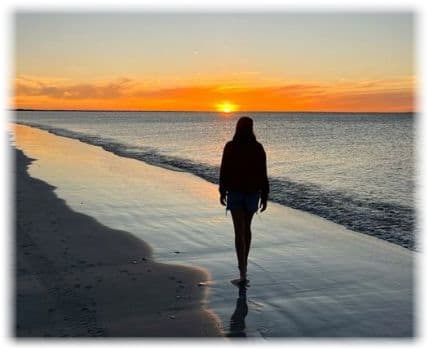 Person walking on ocean beach