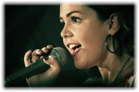 Woman singing into mic