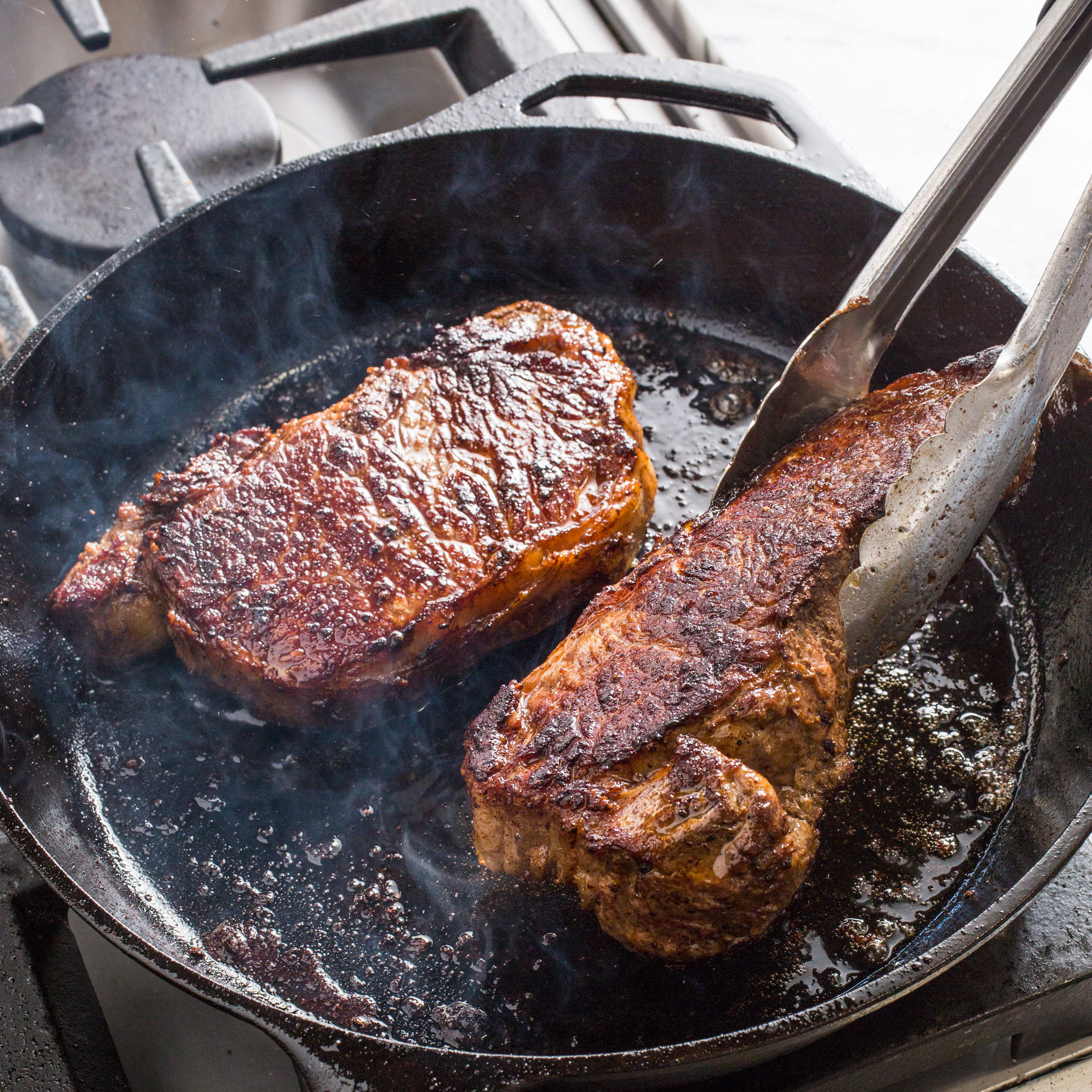 How to cook a steak using a cast iron skillet Cast Iron Steaks With Herb Butter America S Test Kitchen