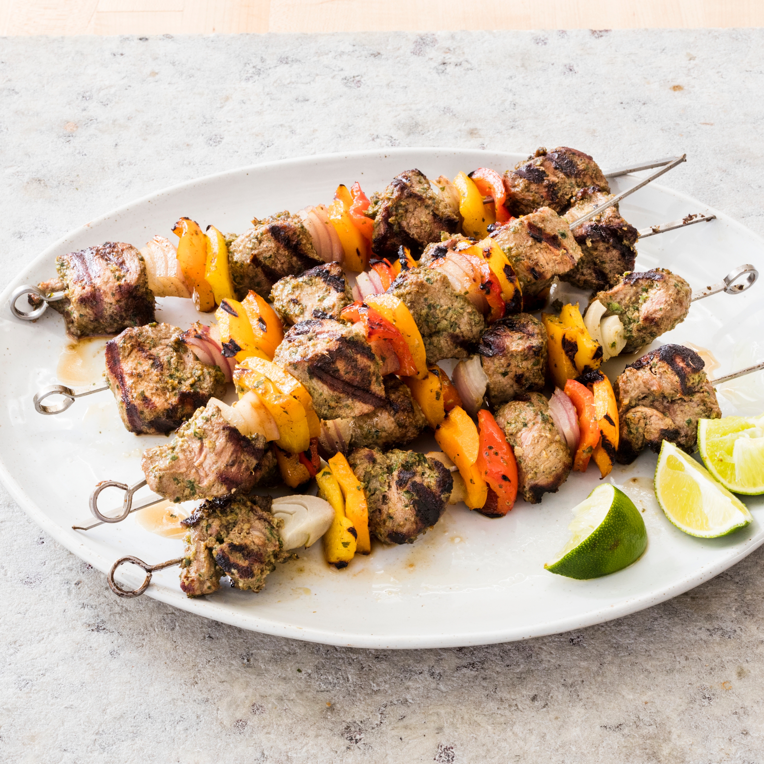 Grilling Marinated Shashlik On A Grill. Shashlik Is A Form Of Shish Kebab  Popular In Eastern, Central Europe And Other Places. Shashlyk (meaning  Skewered Meat) Was Originally Made Of Lamb. Stock Photo