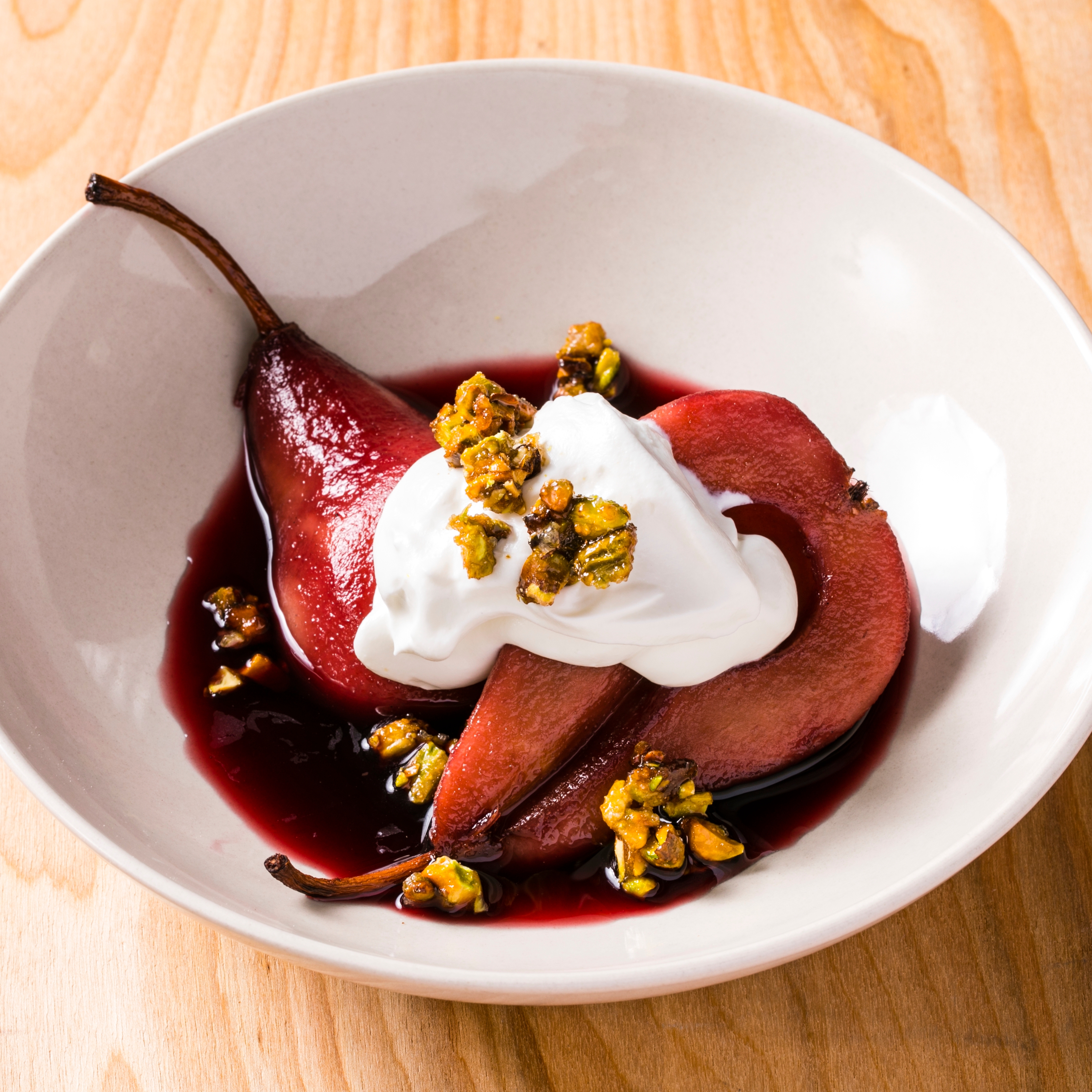 Sous Vide Red Wine-Poached Pears with Whipped Sour Cream and Candied Pistachios | America's Test Recipe