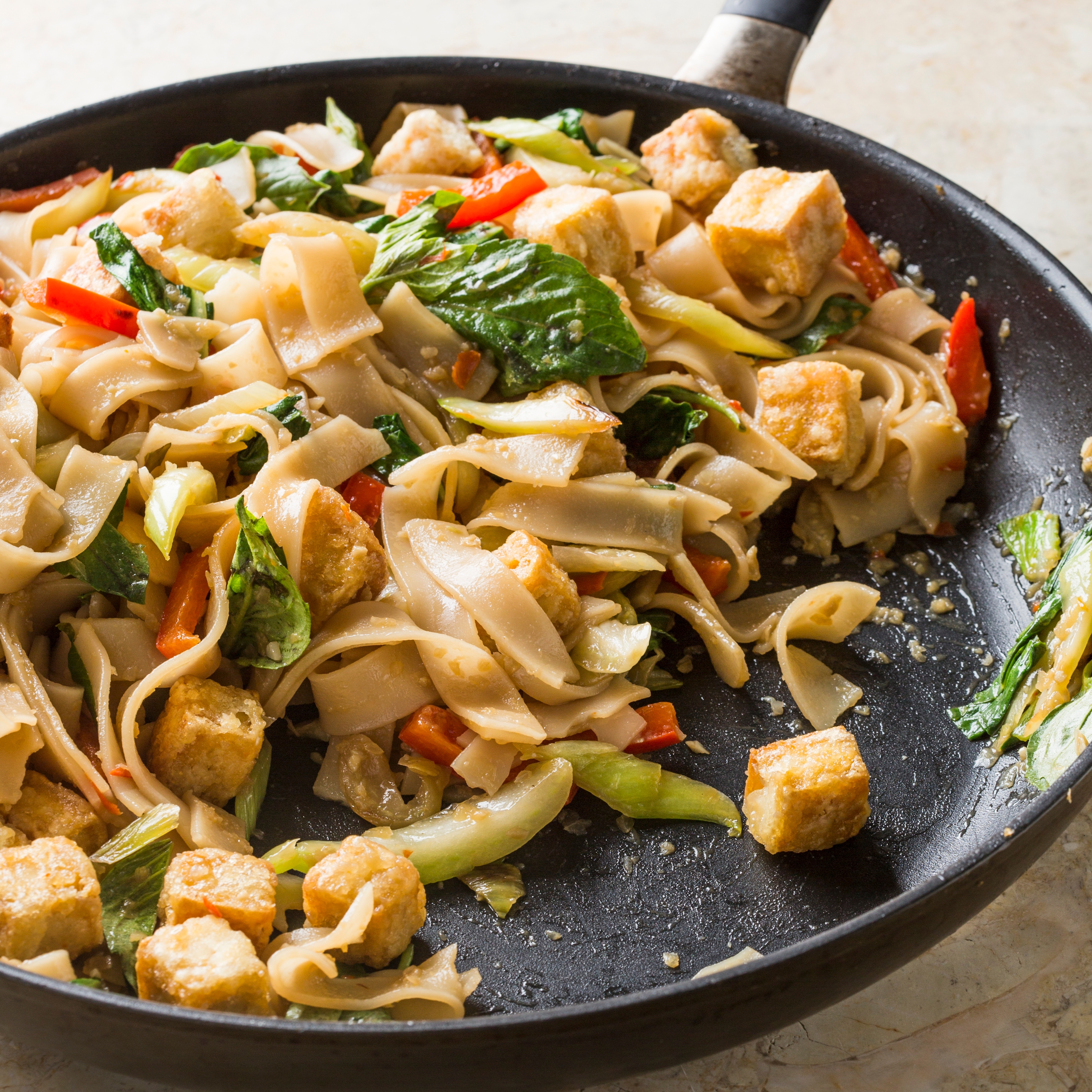 Vegan Spicy Basil Noodles with Crispy Tofu Bok Choy and Bell Peppers