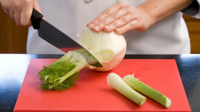 Slicing the stalks off a fennel bulb. 